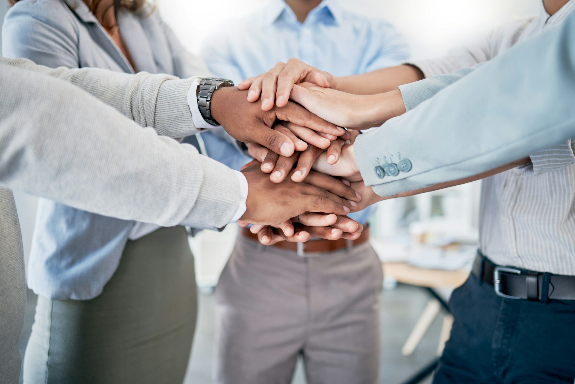Collaboration, teamwork and hands stacked for solidarity, support and staff diversity mission in bu